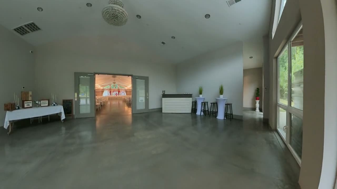 FPV drone flying through the front door of an event venue